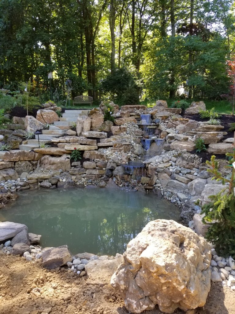 custom pond with rock wall