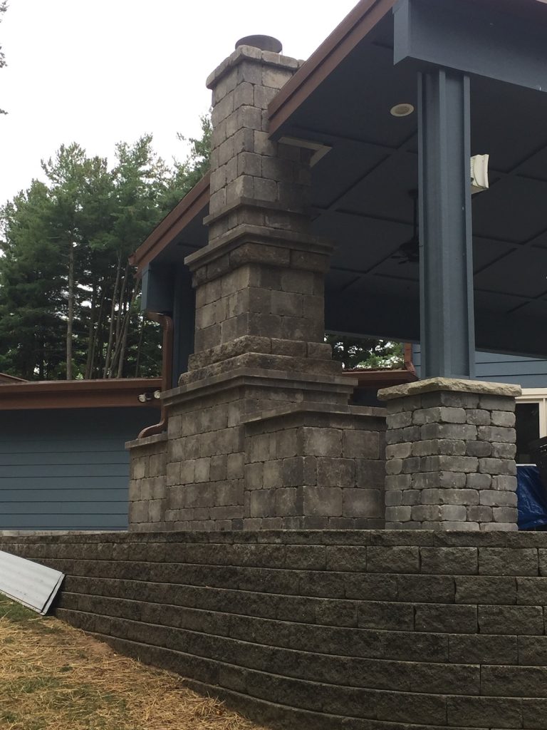 Custom home chimney connected to ceiling of a patio